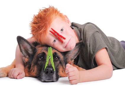 A boy and his dog wear clothes pins so that they don't smell stinky waste holding tank odors.