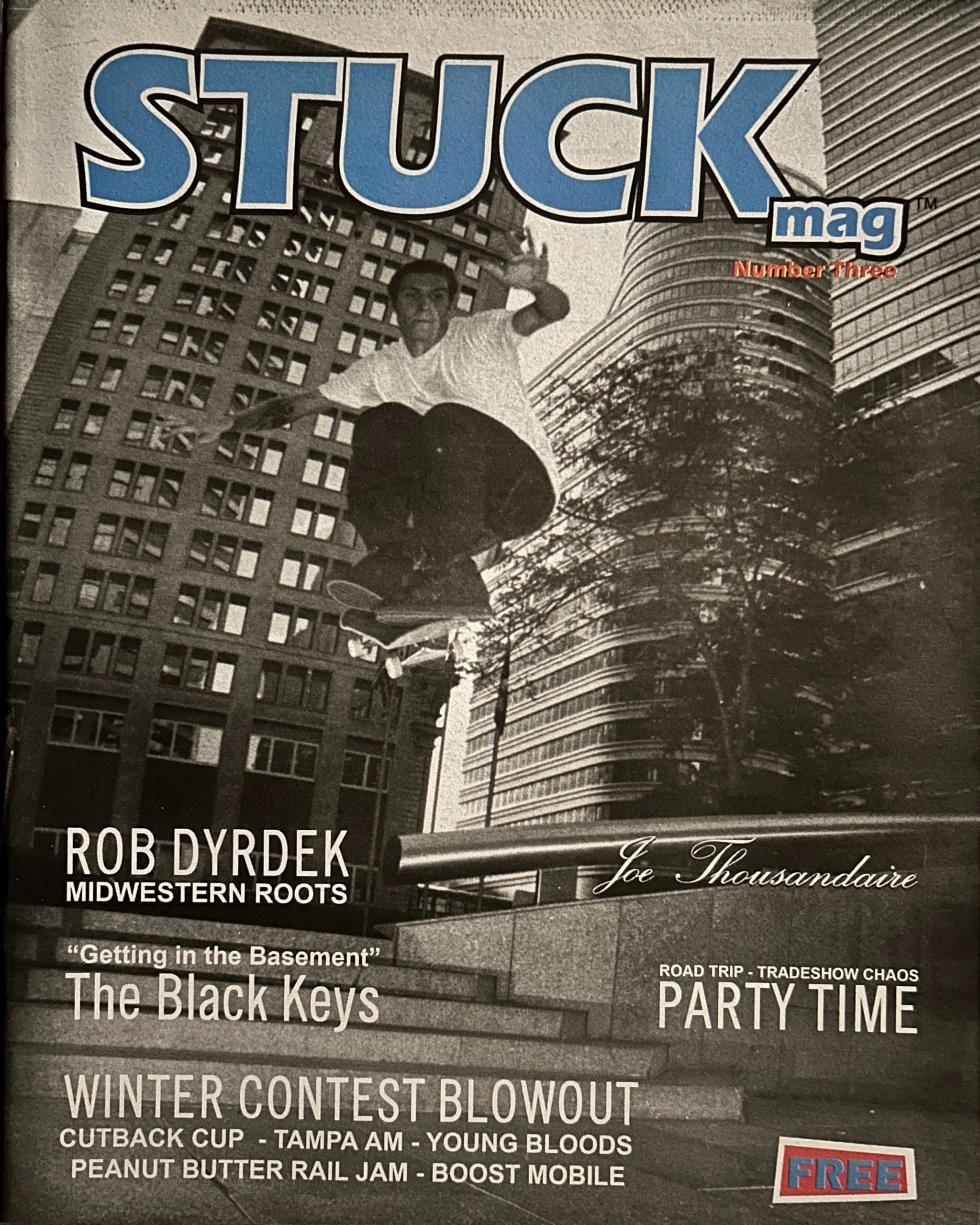 Skateboarder in mid-air on a city street, cover of STUCK mag.