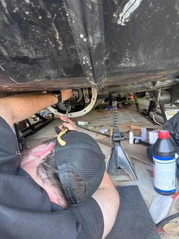 Mechanic repairing rear axle on Jeep Cherokee