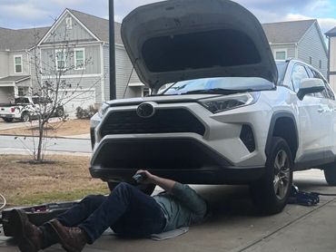 Parker doing maintenance and changing oil on Toyota Rav4