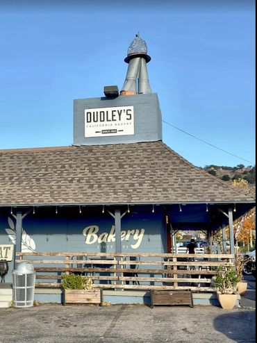 Exterior view of Dudley's California Bakery with clear skies.