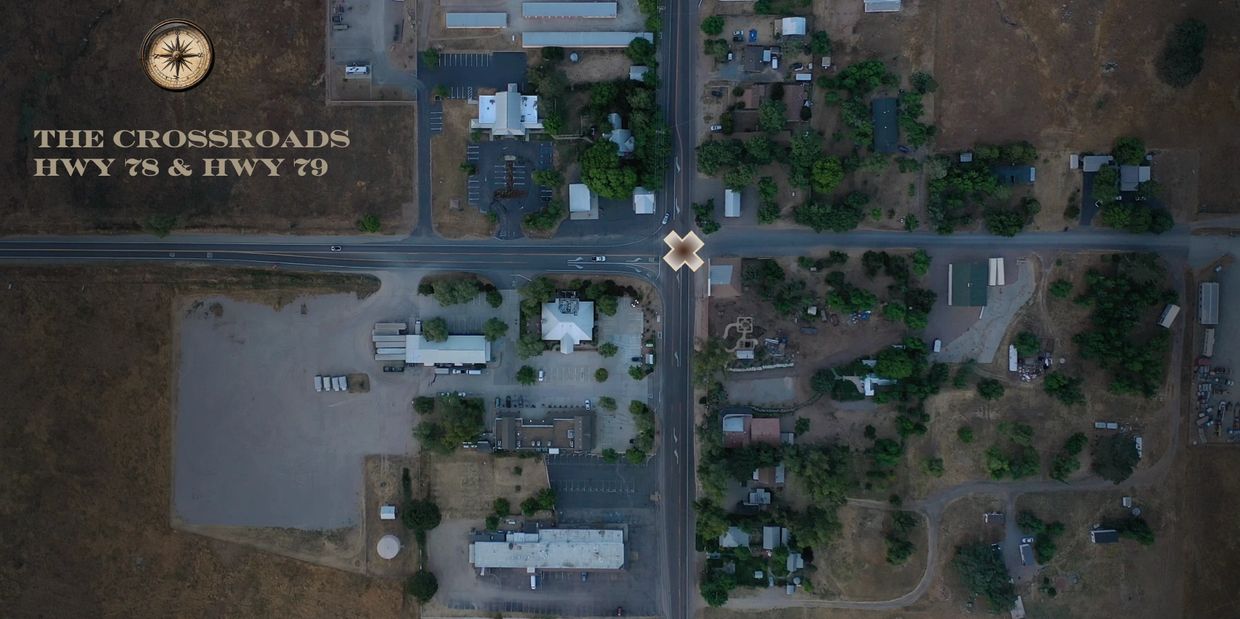 Aerial view of the crossroads at HWY 78 and HWY 79 with buildings and vegetation.
