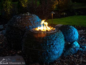 Fire & Water Stacked Slate Sphere with water running and fire burning at night
