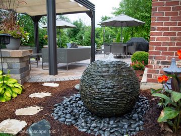 stacked slate sphere with running water installed in front yard
