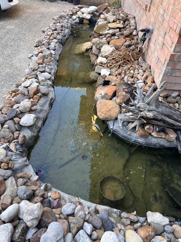 Flooded man-made stream with old water.
