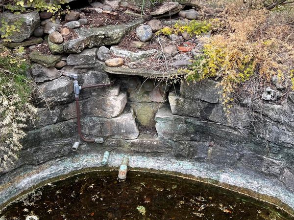 Broken and flooded Pondless waterfall with old rocks.