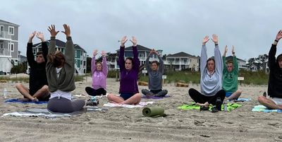 Practicing yoga on the beach is the perfect way to start a wedding morning.