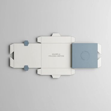 Unfolded white folding carton with blue accents on a plain background.