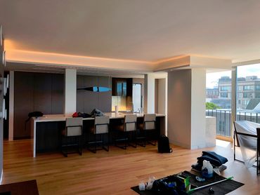 Modern kitchen with a large island and bar stools in a spacious apartment.