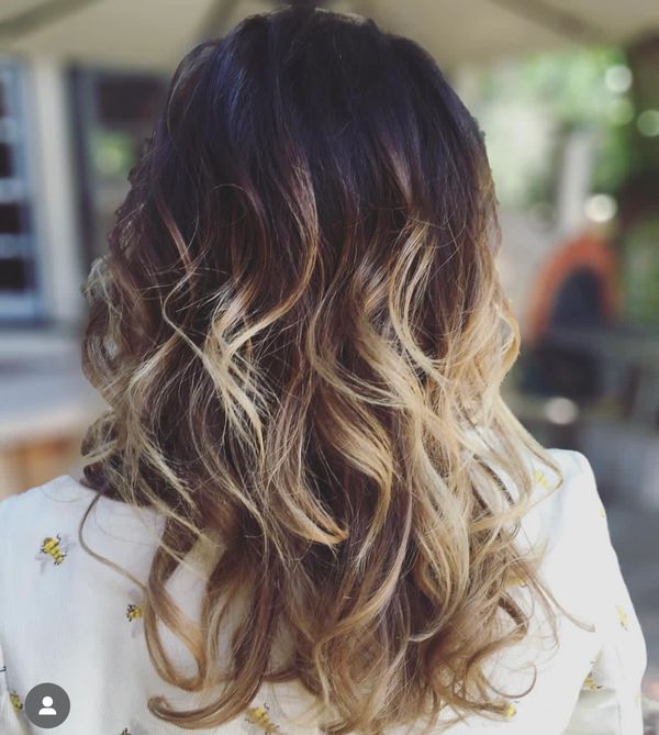 Ombre/balayage technique with a dark contrasting root shade color and textured layers