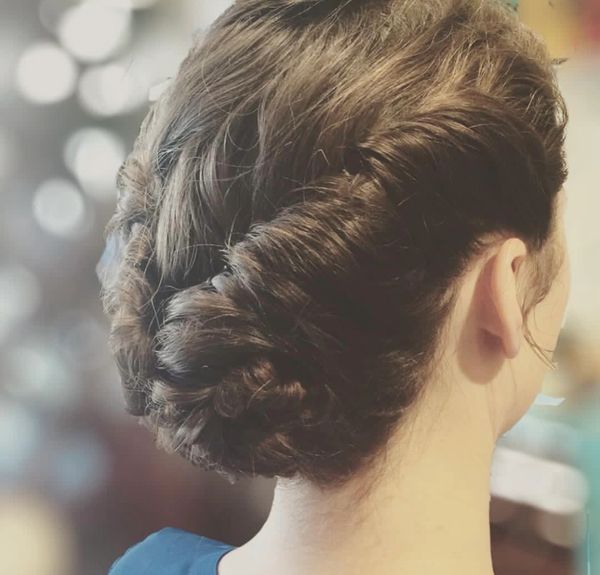 Twisted updo on medium length hair for a wedding event.