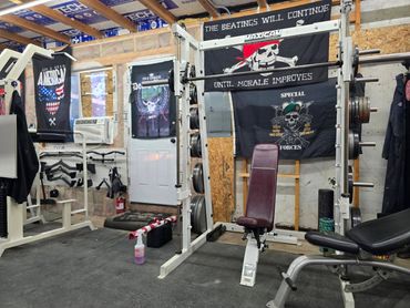Home gym with motivational banners and workout equipment.