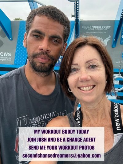Two workout buddies smiling at a fitness court, promoting workout photo sharing.
