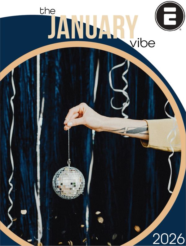 Hand holding a disco ball ornament with festive streamers and confetti.