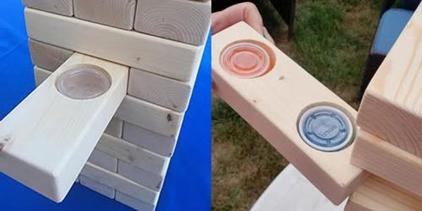 Wooden Jenga blocks with drink holders inserted.