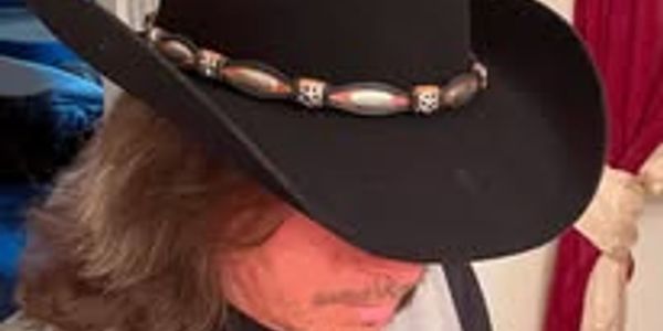 Person wearing a black cowboy hat.