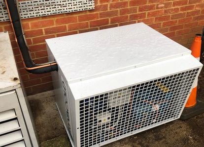 A condensing unit replacement for a walk-in freezer room.