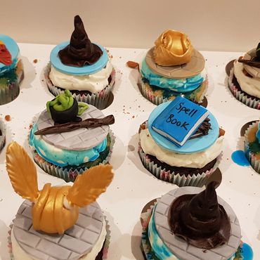 Harry Potter themed cupcakes with iconic symbols and decorations.