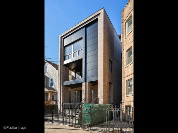 Modern narrow house with black and beige facade.