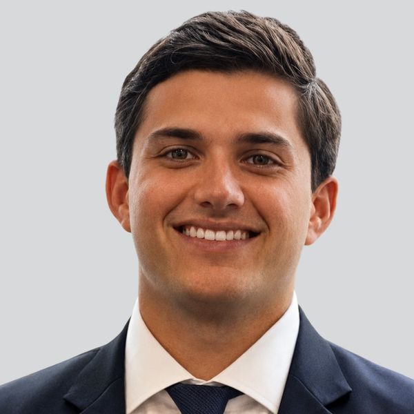 Portrait of a smiling young man in a suit and tie.