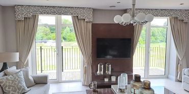 Dual twin pleated curtains with tie backs onto balcony