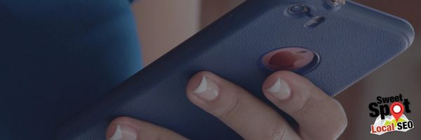 picture of a woman holding an iPhone.