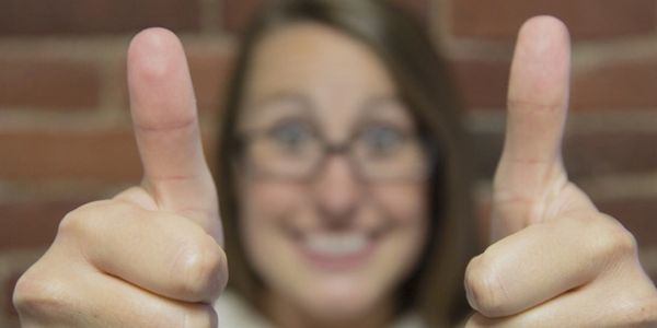 picture of a woman giving two thumbs up.