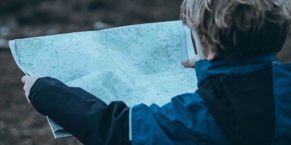 picture of a little kid looking a map