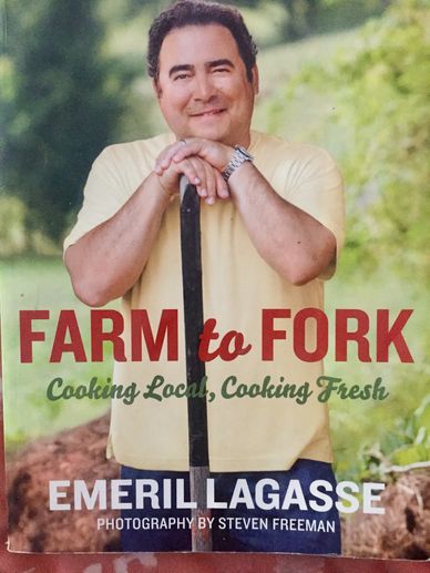 Photo of Emeril with what looks like a hoe. He's working in his garden.