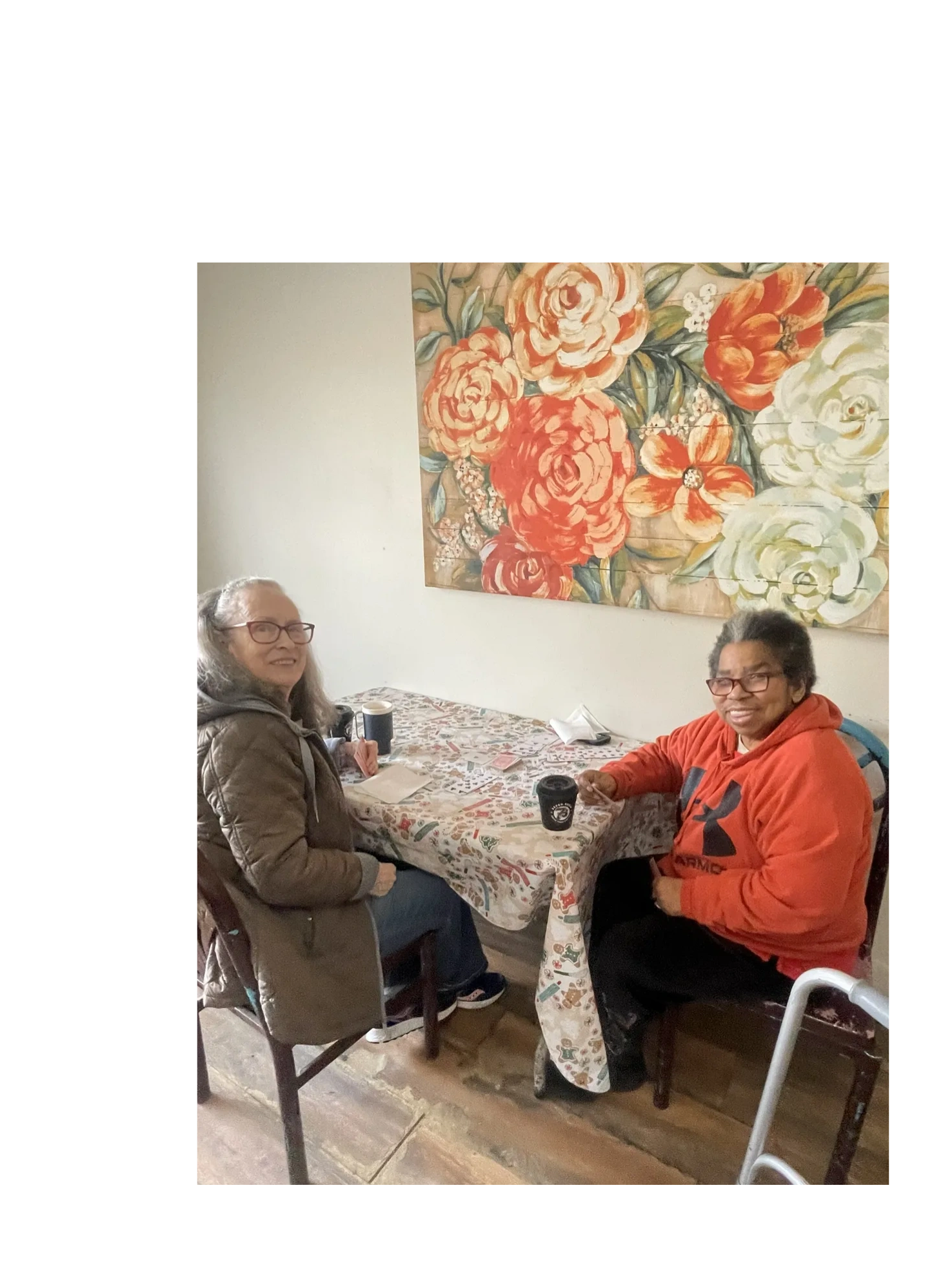 Two Residents smiling and enjoying a cup of coffee
