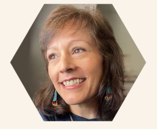 Maria-Lupita is smiling looking out the windo.