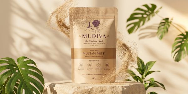 Mudiva Multani Mitti natural clay face mask with plants and floating clay powder.