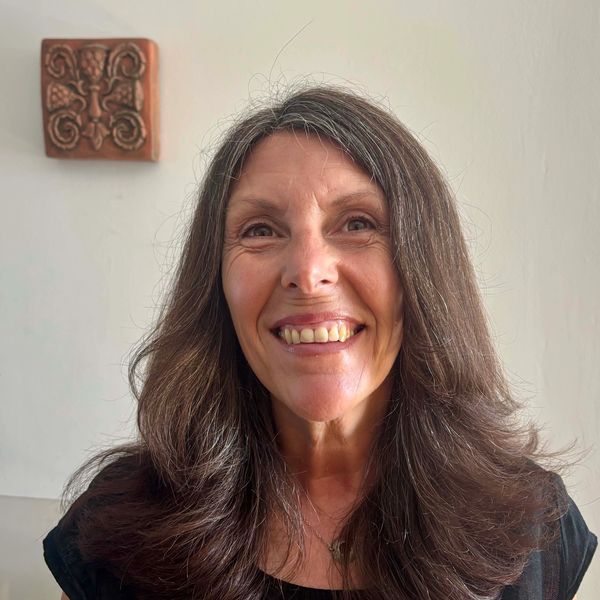 Smiling woman with long brown hair.