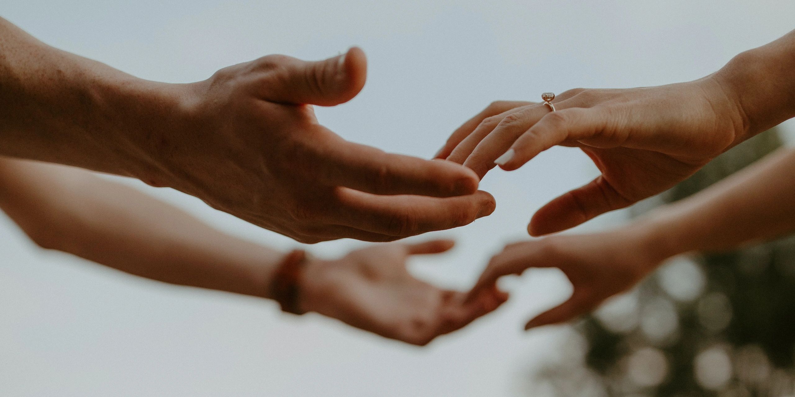 Two pairs of hands reaching towards each other, one with an engagement ring.couples therapy
family therapy
systemic constellation work
healing
connection