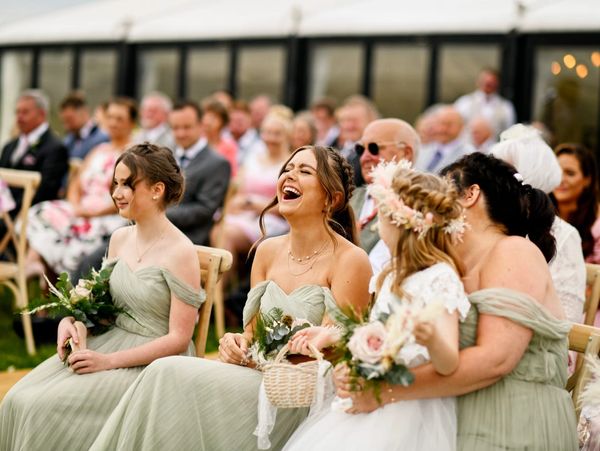 Bridesmaids laughing during celebrant ceremony by Jules Fortune Photography