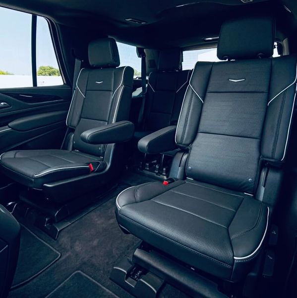 Luxurious black leather seats inside a spacious vehicle cabin.