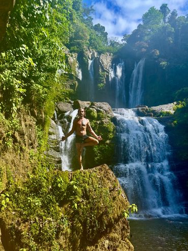 Jared Ruban Costa Rica Balancing on rock at waterfall.