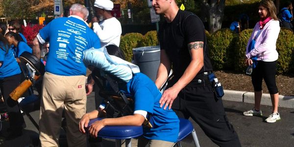Master Therapist Jared Ruban donating massage at cancer walk Englewood Hospital.