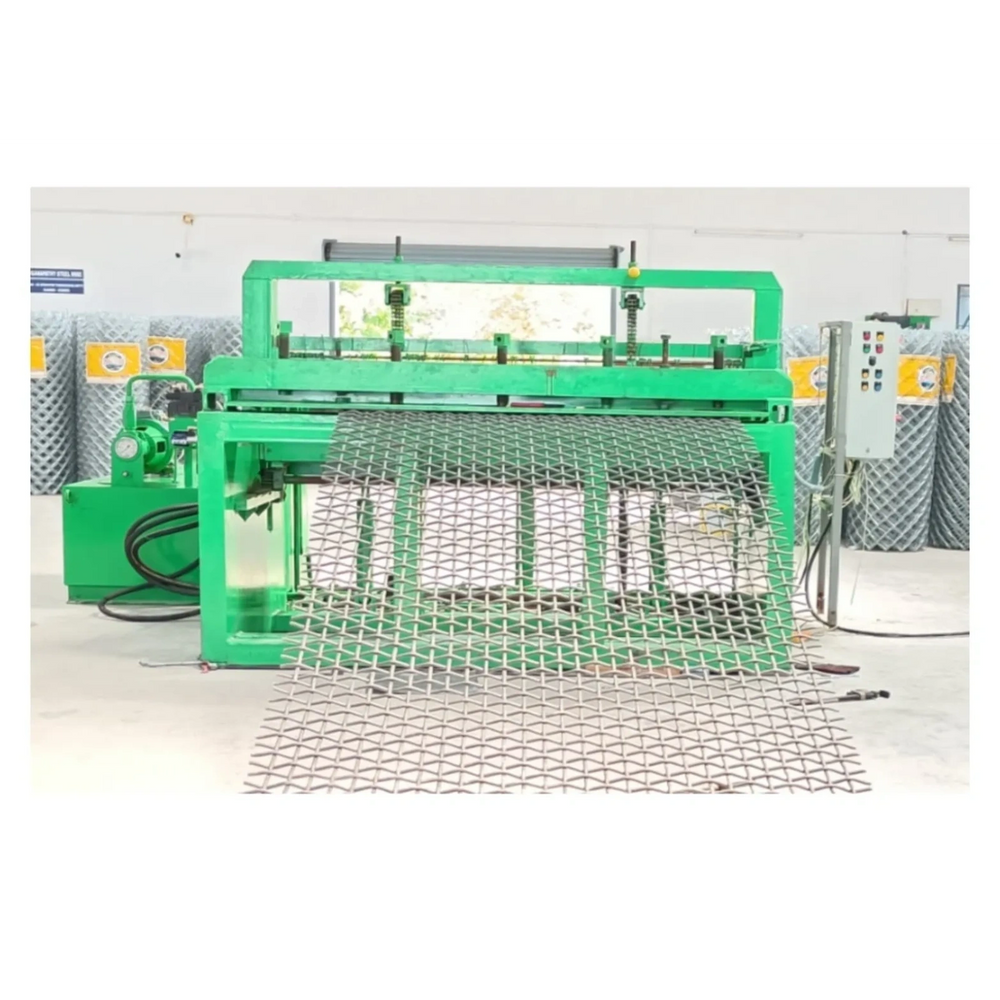 Green industrial machine producing metal mesh sheets indoors.