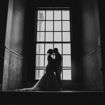 Wedding couple photo in front of large window