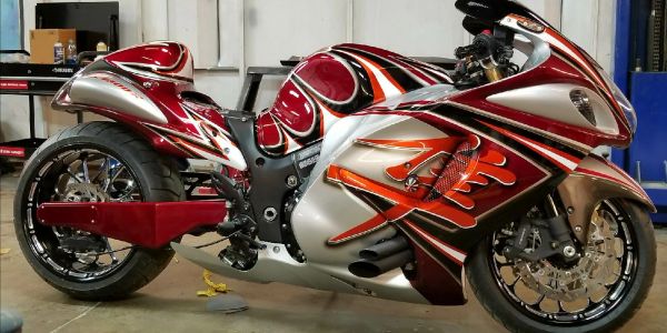 Custom red and silver sport motorcycle with flame decals.