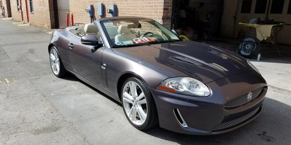 Convertible sports car parked near a building.