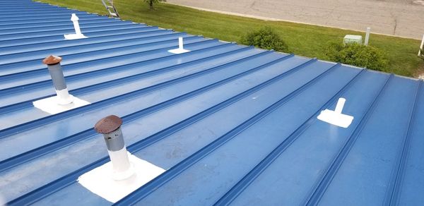 Roof stacks and roof pipes have been sealed using a high solids silicone roof coating.