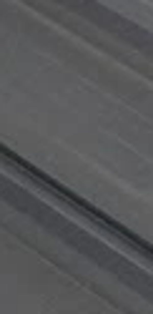 High solids silicone roof sealant has been applied to a failing metal roof seam.