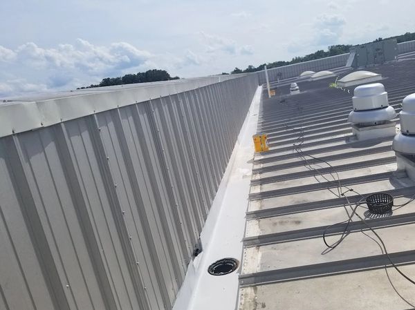 Internal gutters are being resealed with a white elastomeric Roof coating.