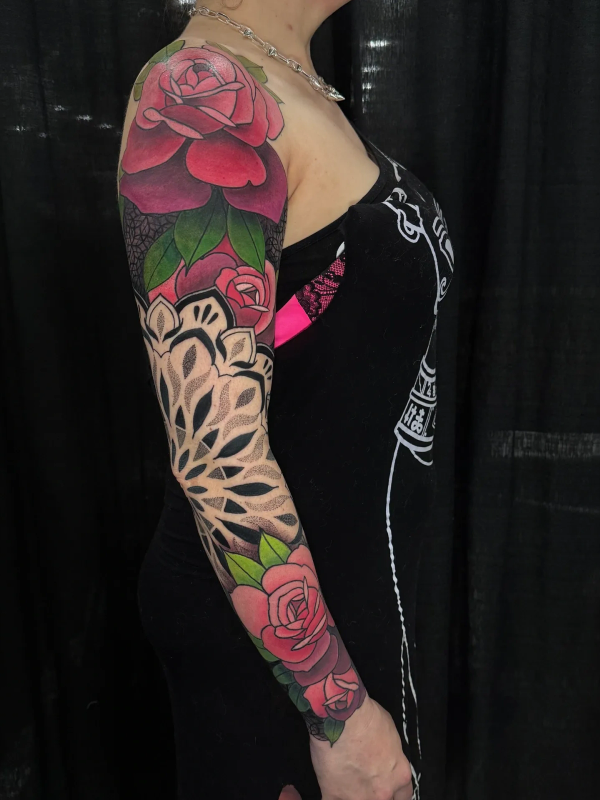 Colorful full sleeve tattoo with roses and mandala design.