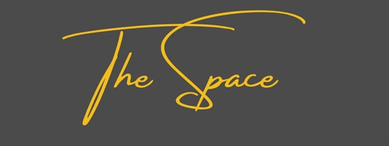 Stylish yellow cursive text 'The Space' on a dark gray background.