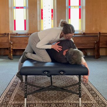 Ilan Lev Method therapist during treatment inside church with stained glass window in background