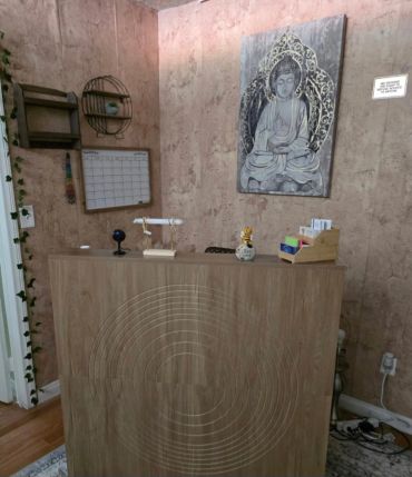 Reception desk with Buddha painting in calm room.
