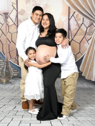 Happy family posing for a maternity photo.